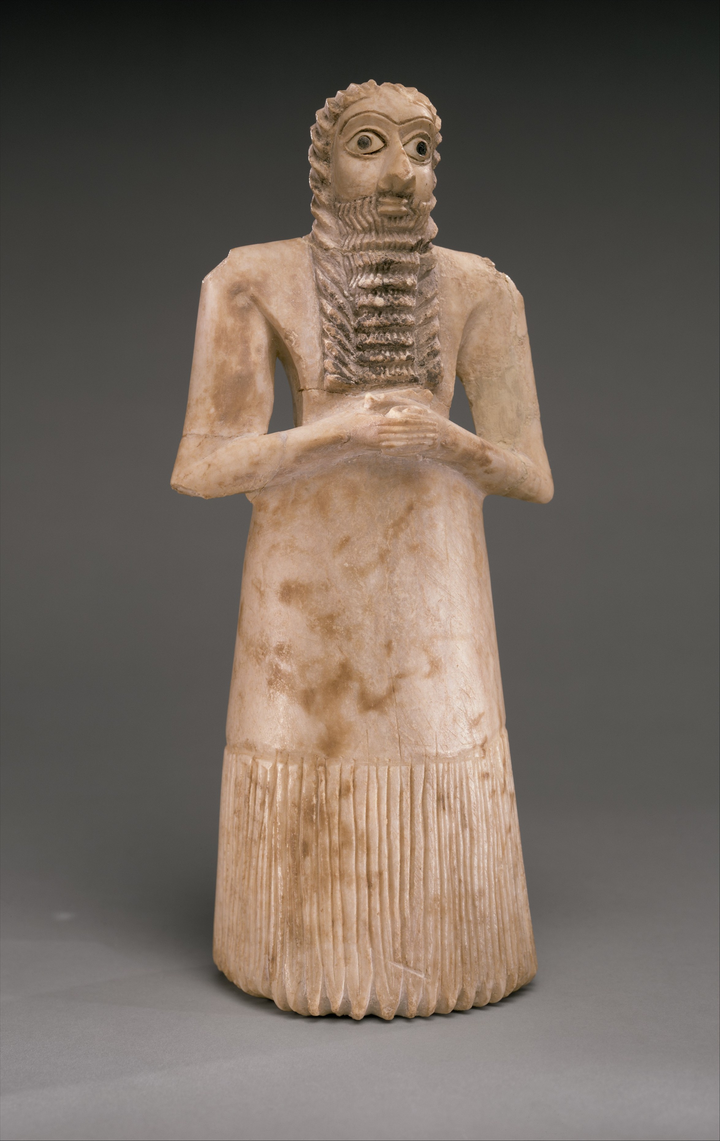 Single Tell Asmar worshipper statue with clasped hands and shell-inlaid eyes